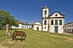 Horse grazes in front of the Igreja Santa Rita dos Pardos Libertos built in 1722.