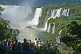 Image of Travellers admire the waterfalls and jungle at the Iguazu Falls.