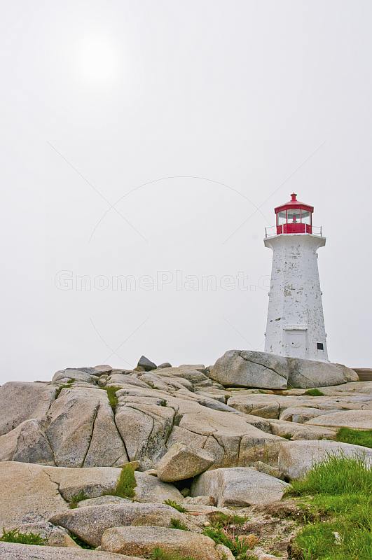 Sun struggles to shine on Peggy\\'s Cove lighthouse tower.