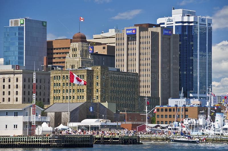 Crowds throng the busy downtown Waterfront to watch a parade of tallships.