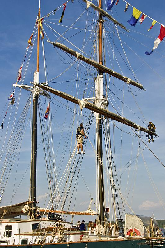 Crewmen work aloft on the rigging of the schooner 'Fair Jeanne'.