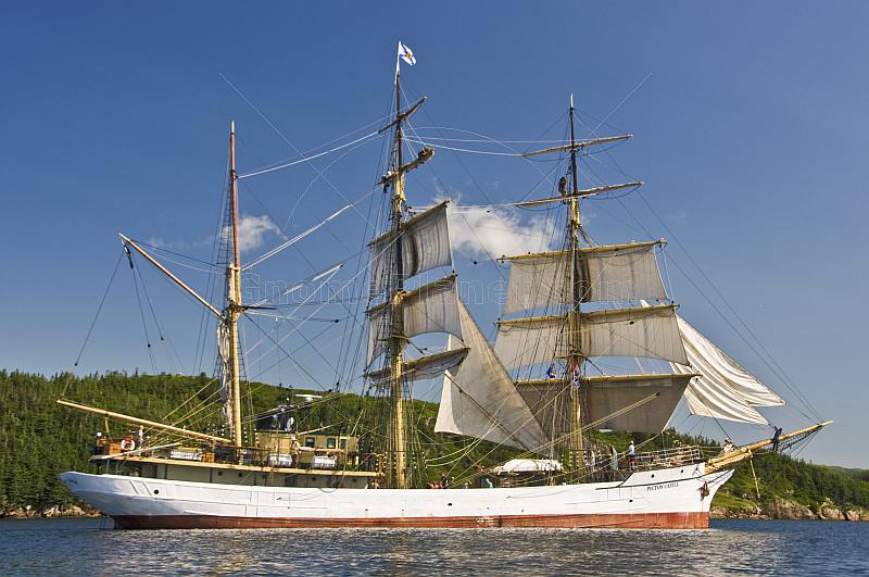 Crew climb the masts and unfurl sail as the barque 'Picton Castle' journeys towards the ocean.