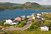 View over the town to the ocean inlet with coniferous forests and mountains.