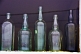 Image of Antique drinks bottles in the window of a Curios shop.