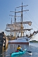 Image of A canoeist watches the tallship 'Picton Castle' prepare to set sail and  leave port.
