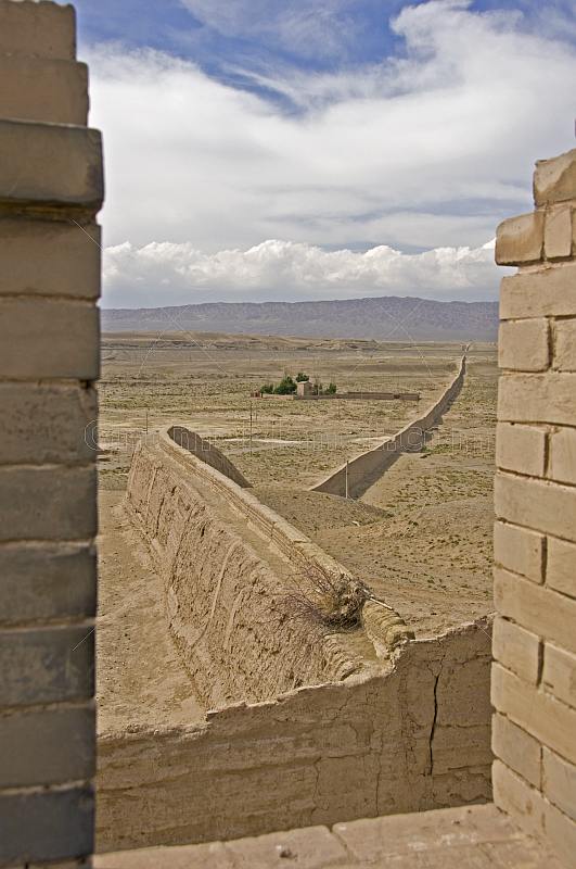 The Great Wall of China snakes away across the desert from the Jiayuguan Fort.