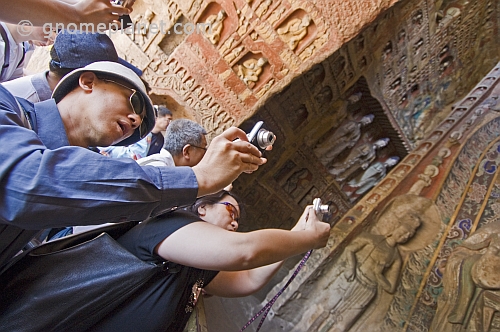 Chinese tourists visit the Yungang Buddhist caves.
