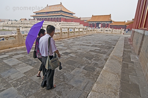 Two Chinese tourists visit the Forbidden City.