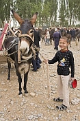 Smiling boy with his mule at the Sunday Market.