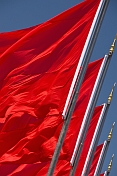 Red flags billowing in the wind of Tiananmen Square.