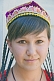 Uighur girl with plaited hair and traditional embroidered hat.