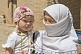 Uighur woman wearing headscarf, with small child.