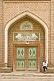 Image of Muslim man sitting next to the entrance door to a mosque.