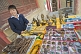 Image of Chinese lady with calculator selling Chinese curios and souvenirs.