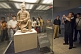 Image of Chinese visitors admire a kneeling Terracotta Archer.