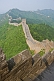 Image of The Great Wall of China crossing forested hills and mountains.