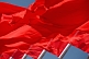 Image of Red flags for the Peoples Republic of China billowing in the wind of Tiananmen Square.