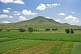 Potatoes, corn, and other vegetable crops grow in fields near the mountains.