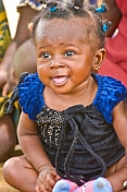 Young Congolese baby in a blue and black dress.