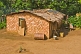 Image of Decorated mud brick house in jungle clearing.