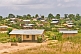 Image of A jumbled village of shacks with corrugated iron roofs.
