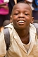 Image of Smiling schoolboy in white shirt enjoys having his photograph taken.