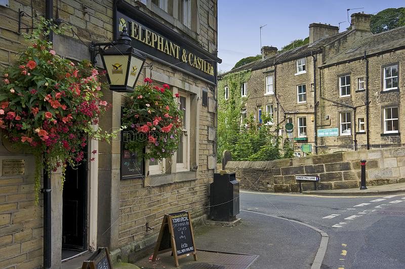 Elephant and Castle public house with hanging flower baskets on Lower Mill Lane Holmfirth.