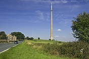 The 330m 1080 feet high Emley Moor TV transmission tower dominates nearby road and houses.