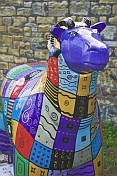 Flock to Skipton sheep sculpture with colored decoration on the Leeds Liverpool canal.