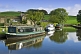 Narrowboats moored next to farm on the Leeds Liverpool Canal on Broughton Road.