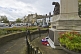 Image of War Memorial with commemorative wreaths on roundabout in the High Street.
