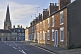 Image of Terraced brick cottages on Olney High Street towards Saint Peter and Saint Paul church.