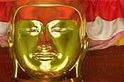 caption: Gold Buddha Face at the Sule Paya Temple